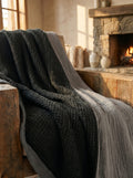 Creative Home's Black waffle weave organic cotton blanket with soft muslin backing styled on rustic wooden bench near fireplace, luxury reversible throw,BB-DesH-WaMusBlnkt-Bla-6070,BB-DesH-WaMusBlnkt-Bla-Tw,BB-DesH-WaMusBlnkt-Bla-Q,BB-DesH-WaMusBlnkt-Bla-K,BB-DesH-WaMusBlnkt-Bla-100118,BB-DesH-WaMusBlnkt-Bla-100125